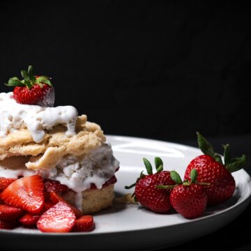 biscuits stacked with strawberries and coconut cream.