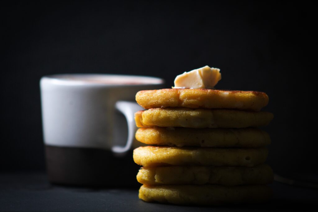 Colombian Arepas stacked with butter on top.