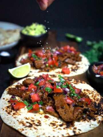 carne asada tacos topped with easy salsa and lime.