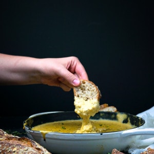 cheese sauce in a skillet with bread.