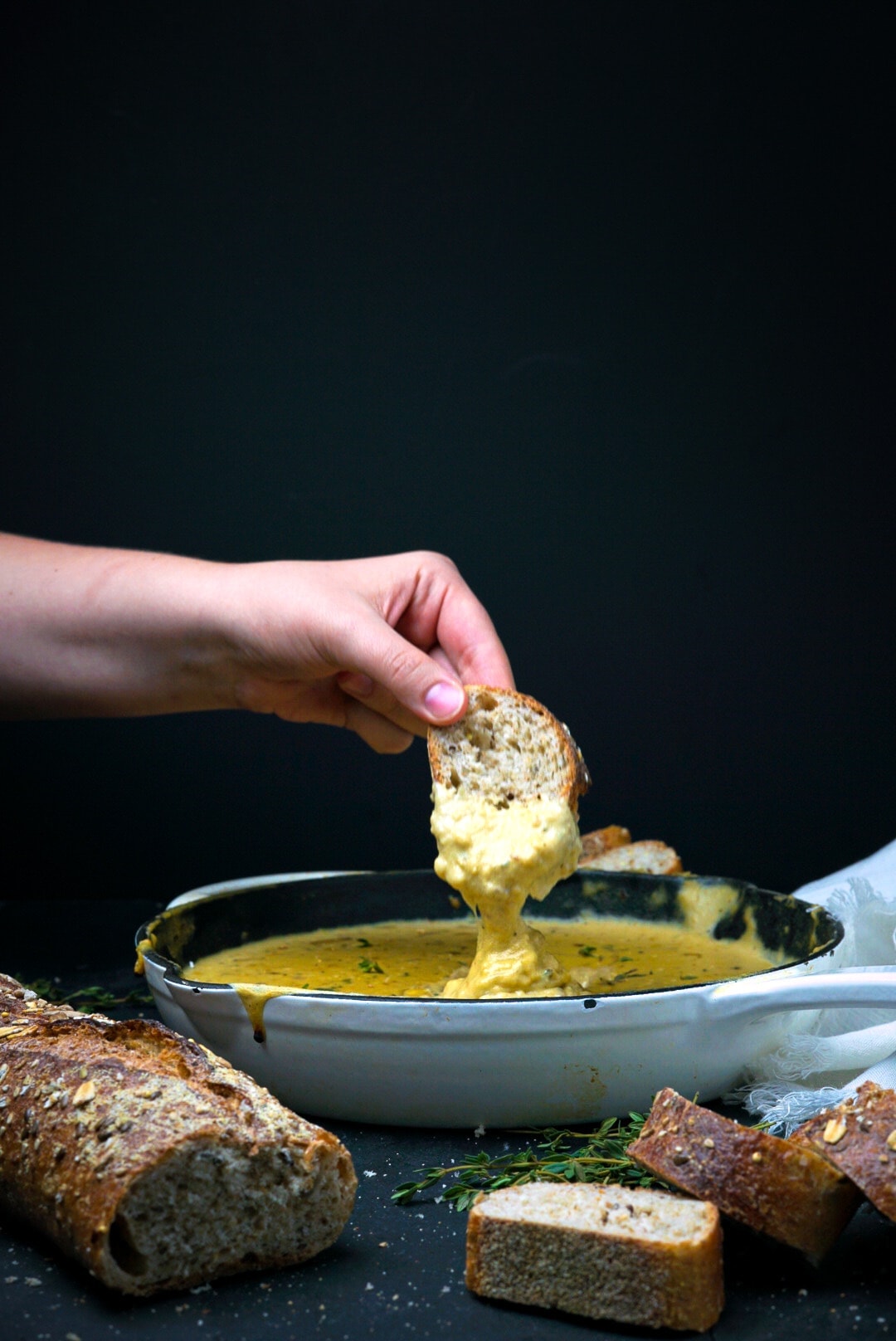 cheese sauce in a skillet with bread.
