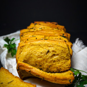 Pumpkin pull apart loaf garnished with parsley.
