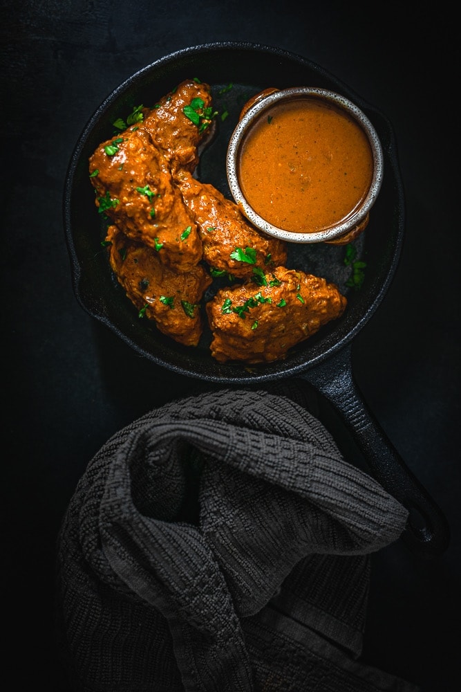 Tikka Masala Wings in a skillet with extra sauce.