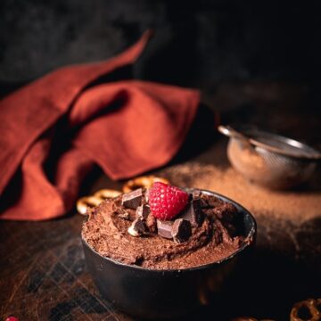 Chocolate Peanut Butter Hummus topped with raspberries and chocolate chunks