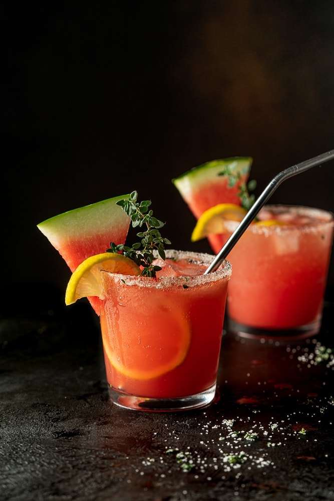 Glass of watermelon lemonade with a watermelon garnish.