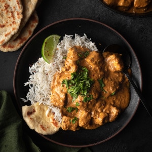 Butter tofu served with naan, basmati rice and cilantro.