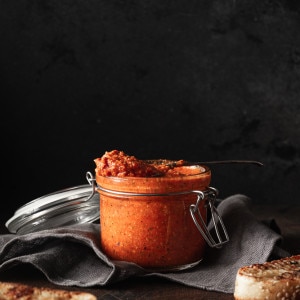 romesco sauce in a small jar with toasted bread.