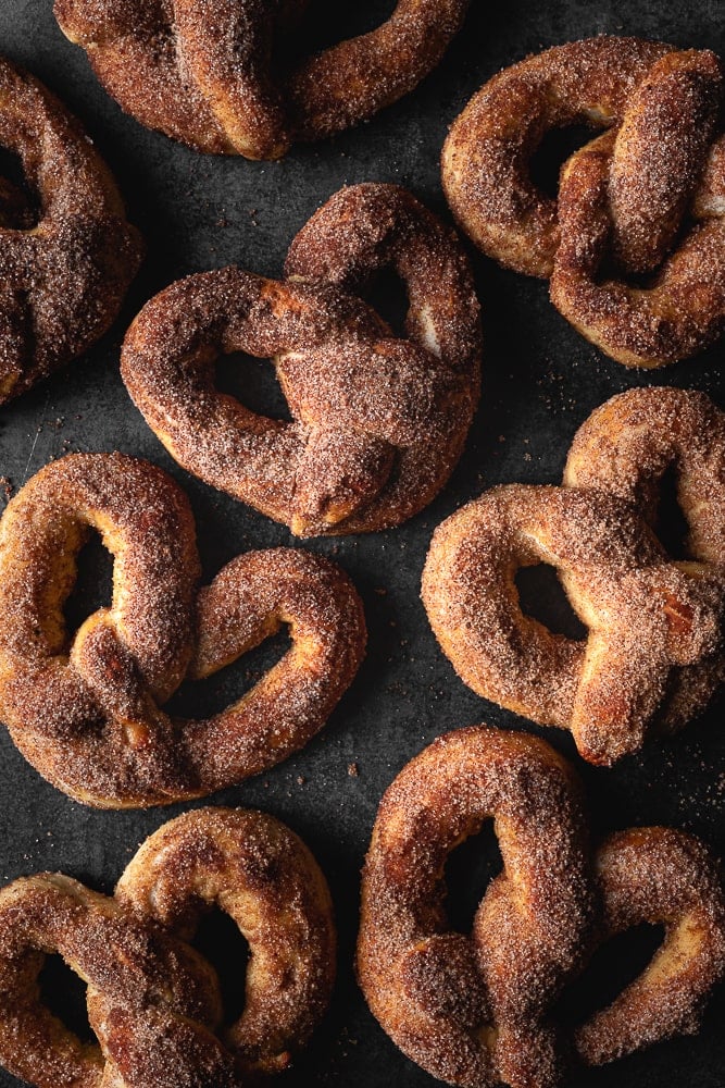 soft pretzels on a tray with cinnamon sugar. 