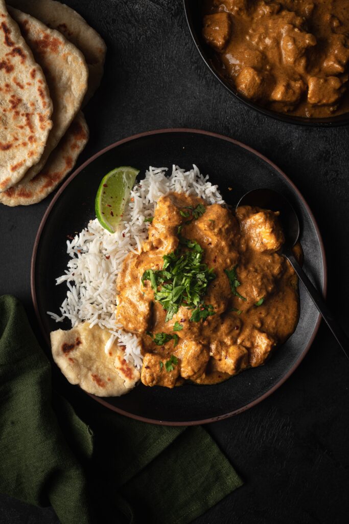 butter tofu served with basmati rice, naan and cilantro.