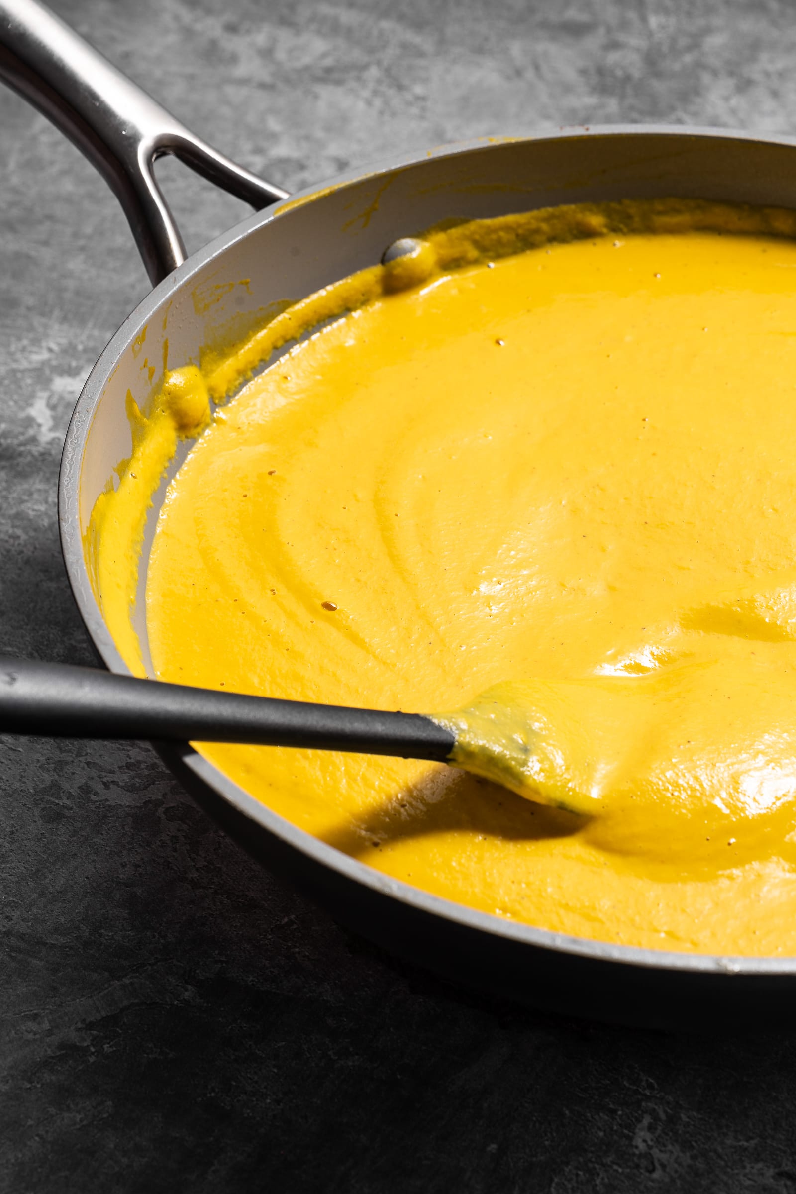pumpkin mac and cheese sauce in a pan.