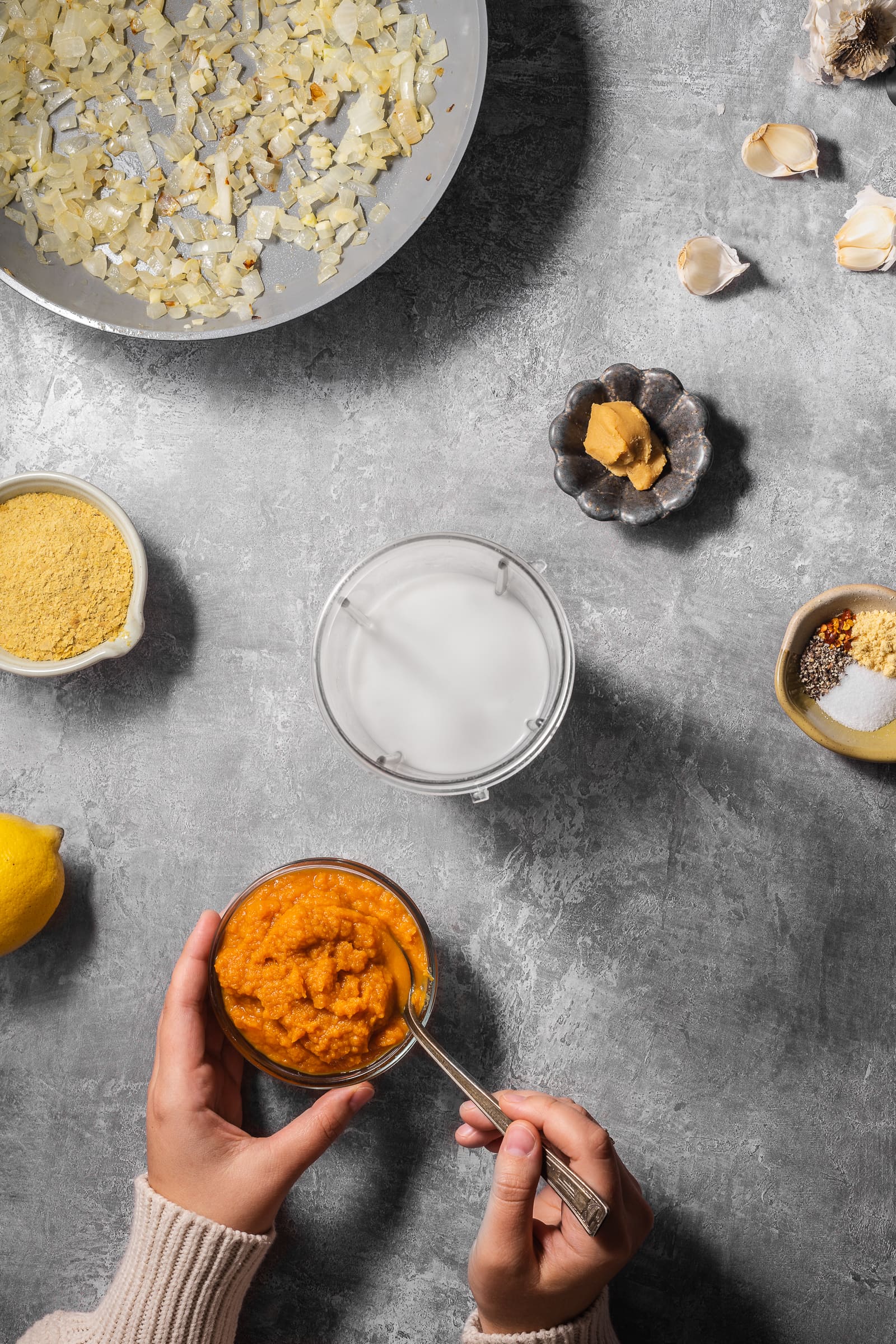 Pumpkin ingredients being placed into a blender.