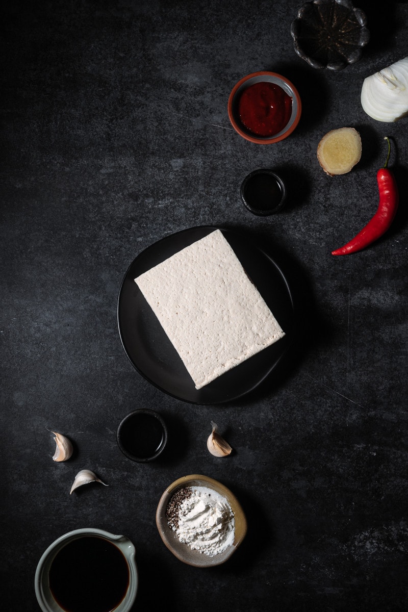 Korean gochujang tofu ingredients lined up on a backdrop.