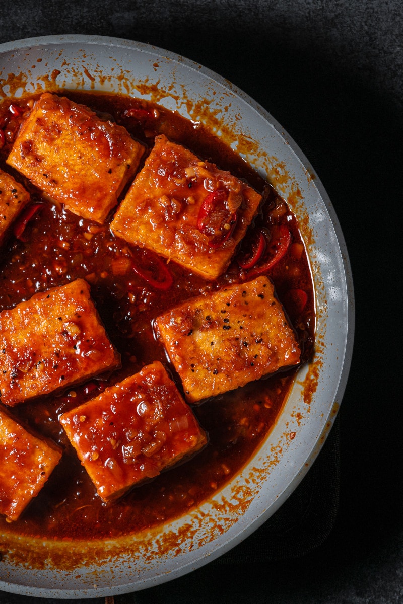 Braised tofu in frying pan.