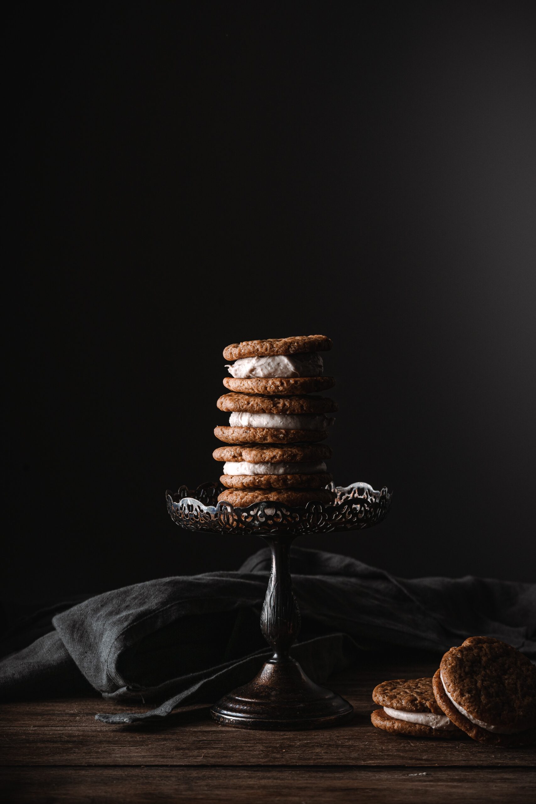 Stack of ginger cookies filled with spiced cream cheese frosting.