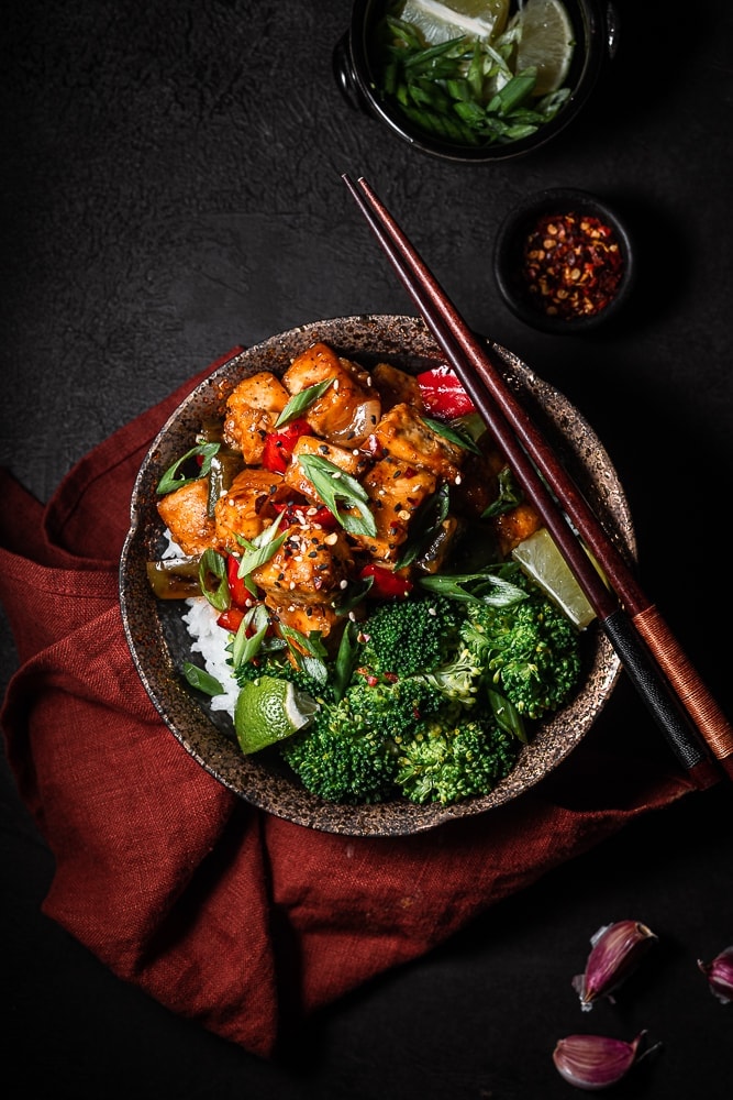 bowl of sesame garlic tofu with rice and broccoli.