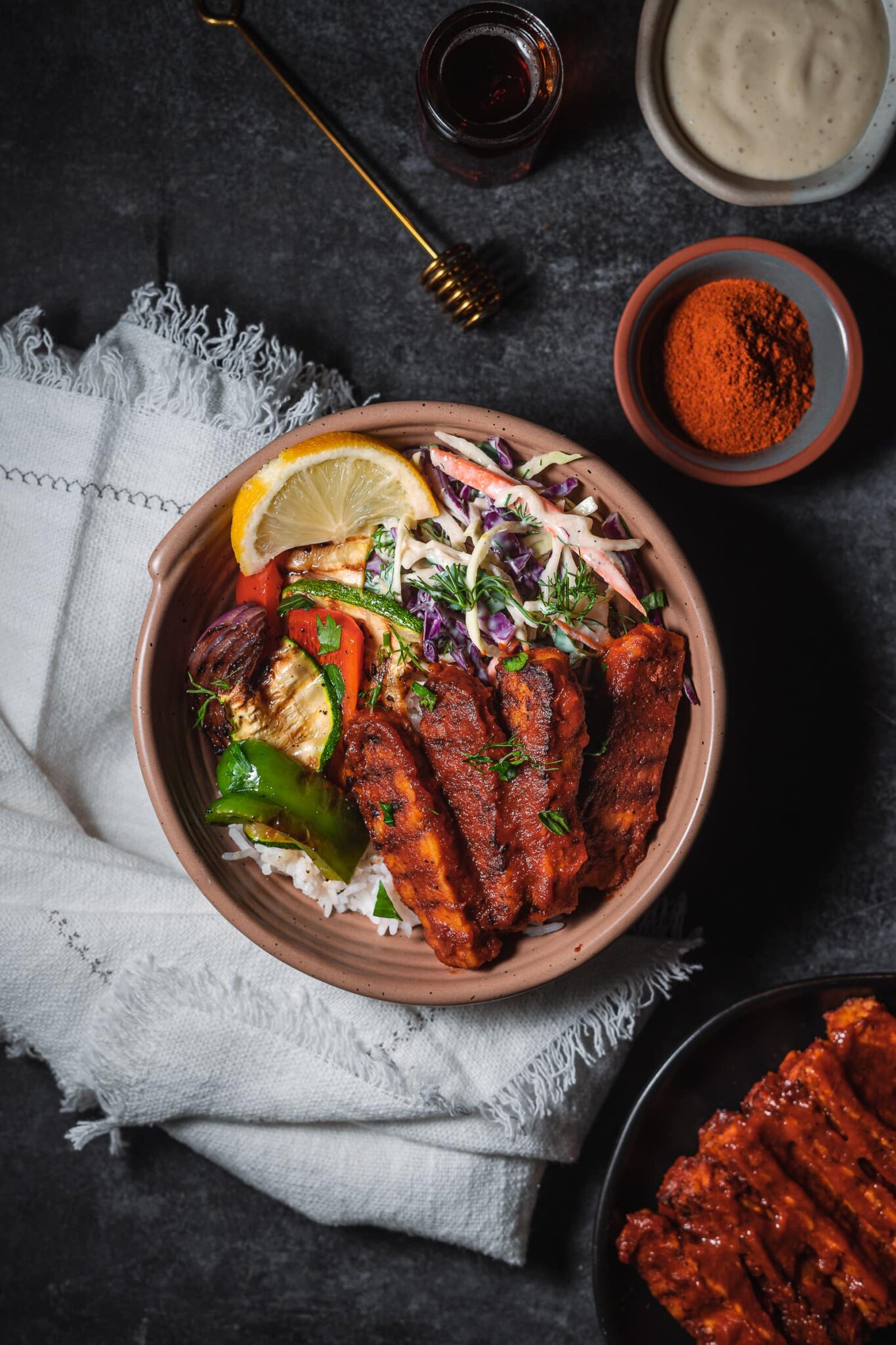 bbq tempeh served with grilled veggies and slaw.