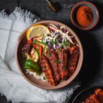 bbq tempeh served with grilled veggies and slaw.