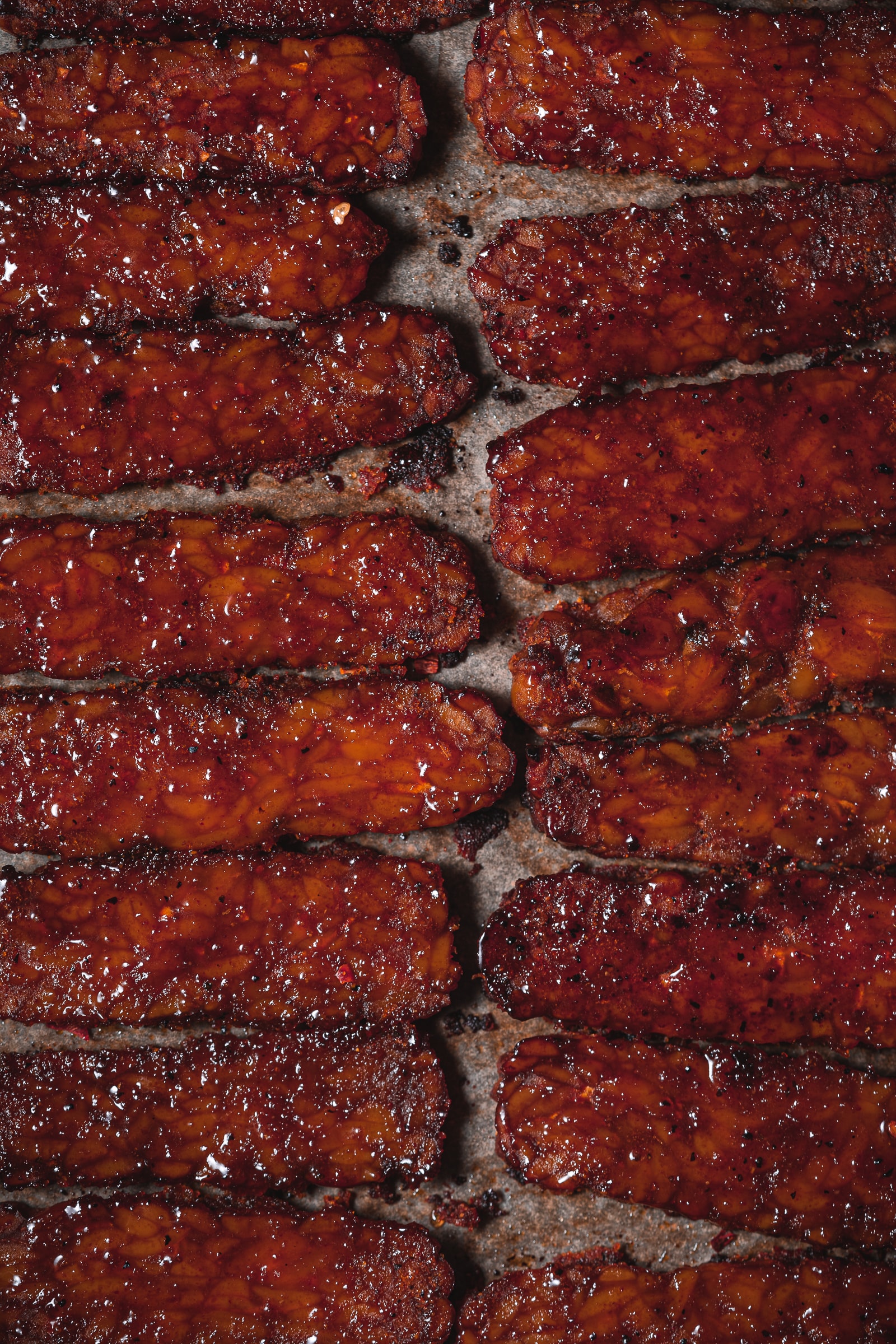 Close up shot of the glaze over the tempeh bacon.