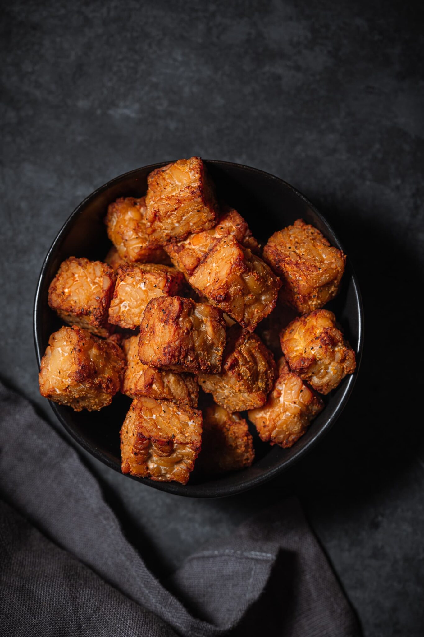 Crispy baked tempeh in a small bowl.