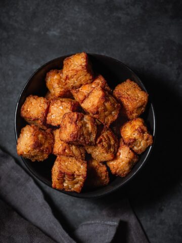 Crispy baked tempeh in a small bowl.