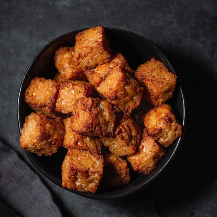 Crispy baked tempeh in a small bowl.