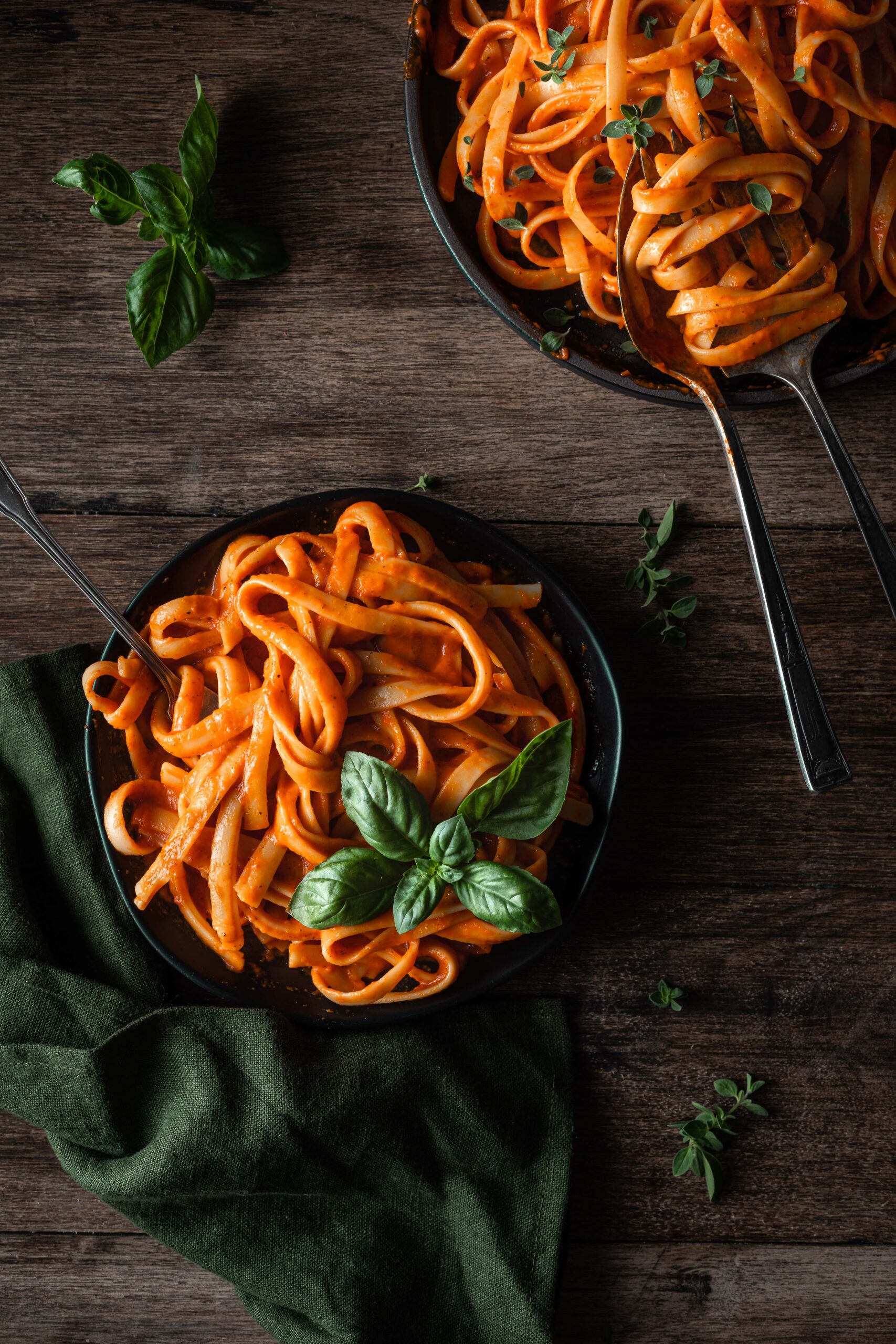 red pepper pasta garnished with basil.