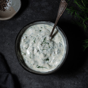 vegan tartar sauce in small bowl garnished with dill.