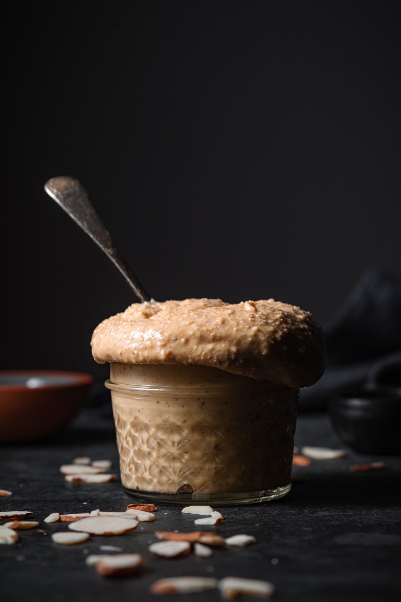 Fresh almond butter in a small jar.
