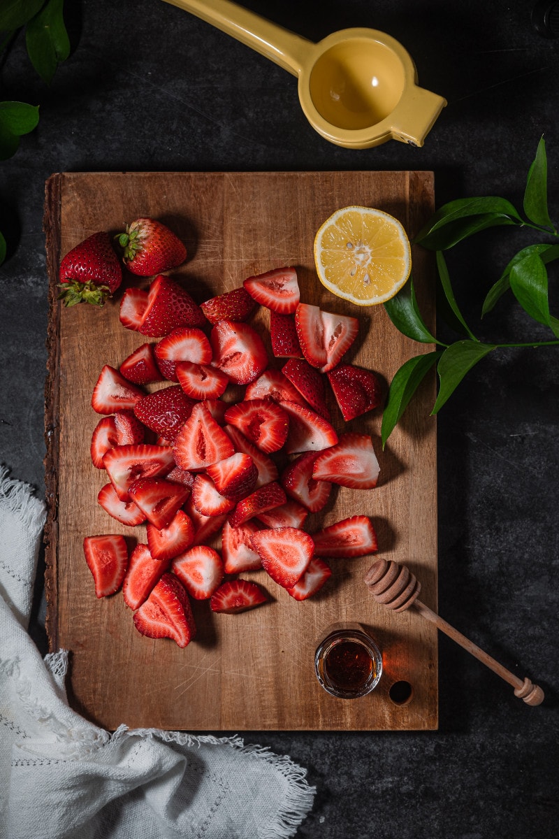Fresh strawberries on a cutting board.