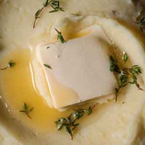 Close up of butter melting on mashed potatoes.