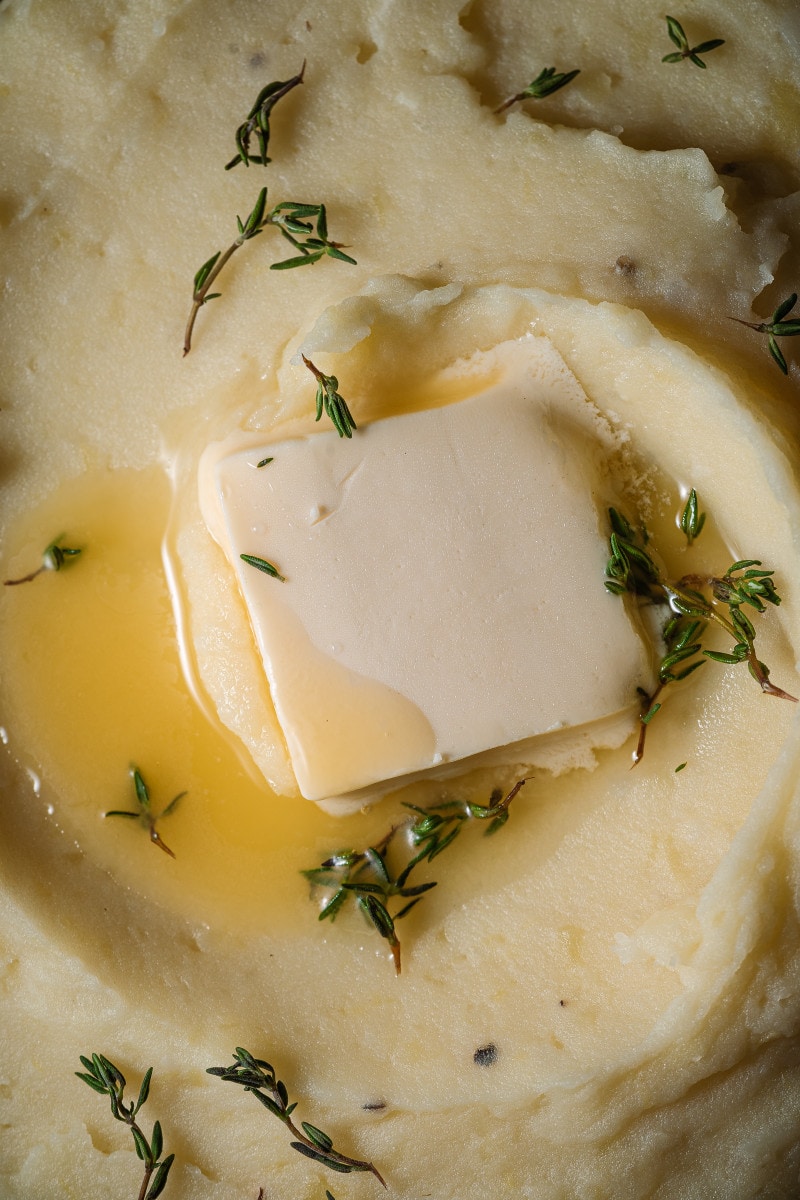 Close up of butter melting on mashed potatoes.