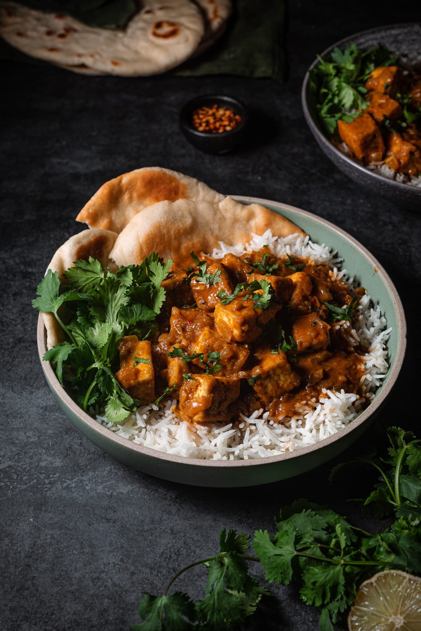 Butter chicken with tofu over basmati rice, cilantro and fresh naan.