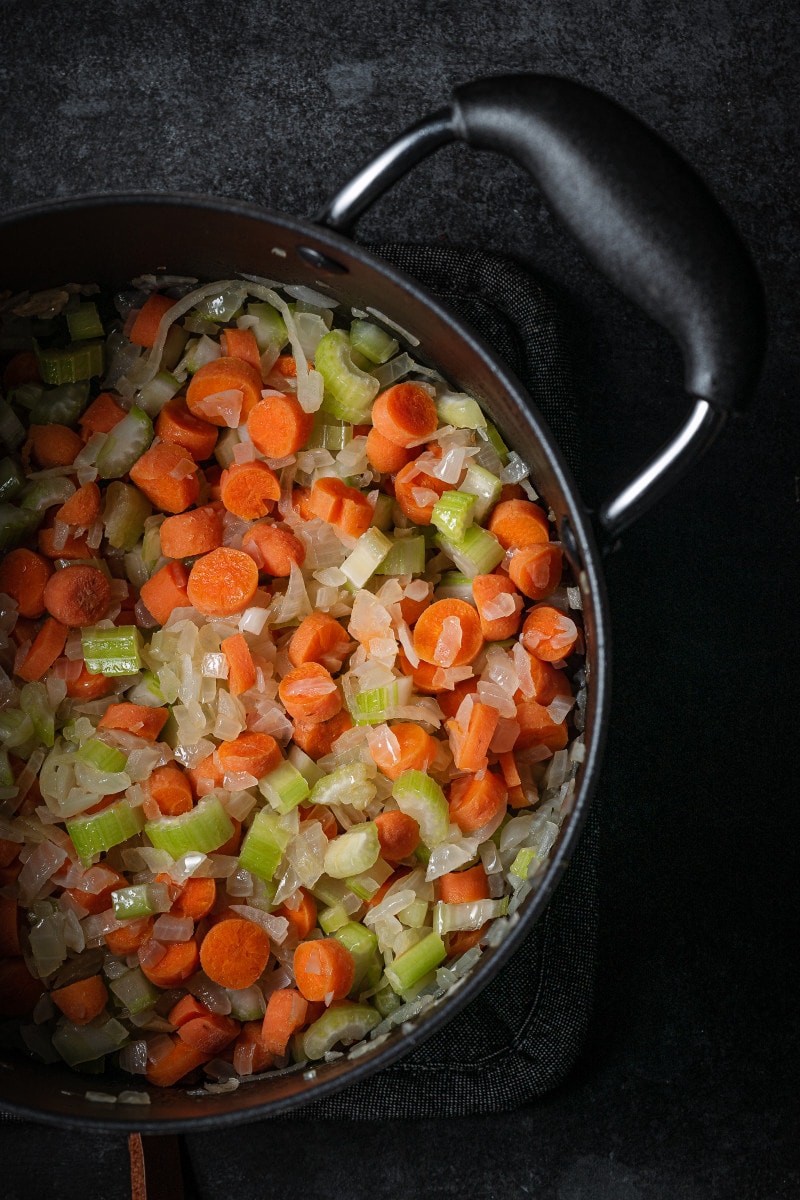 Onions, carrots and celery sautéed in a large soup pot.