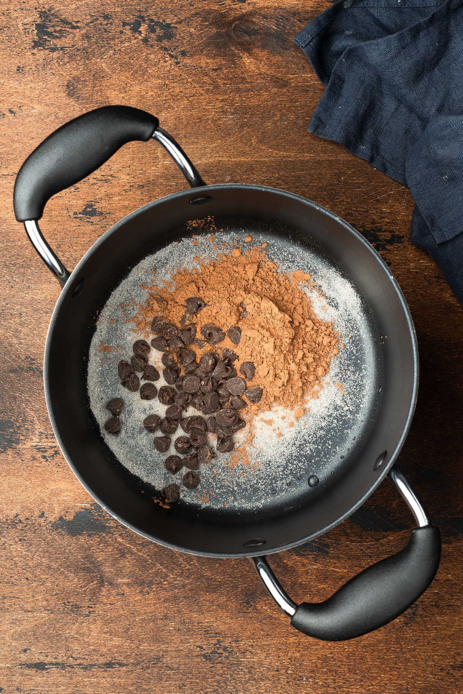 Sugar, cocoa powder, and chocolate chips in a pot.