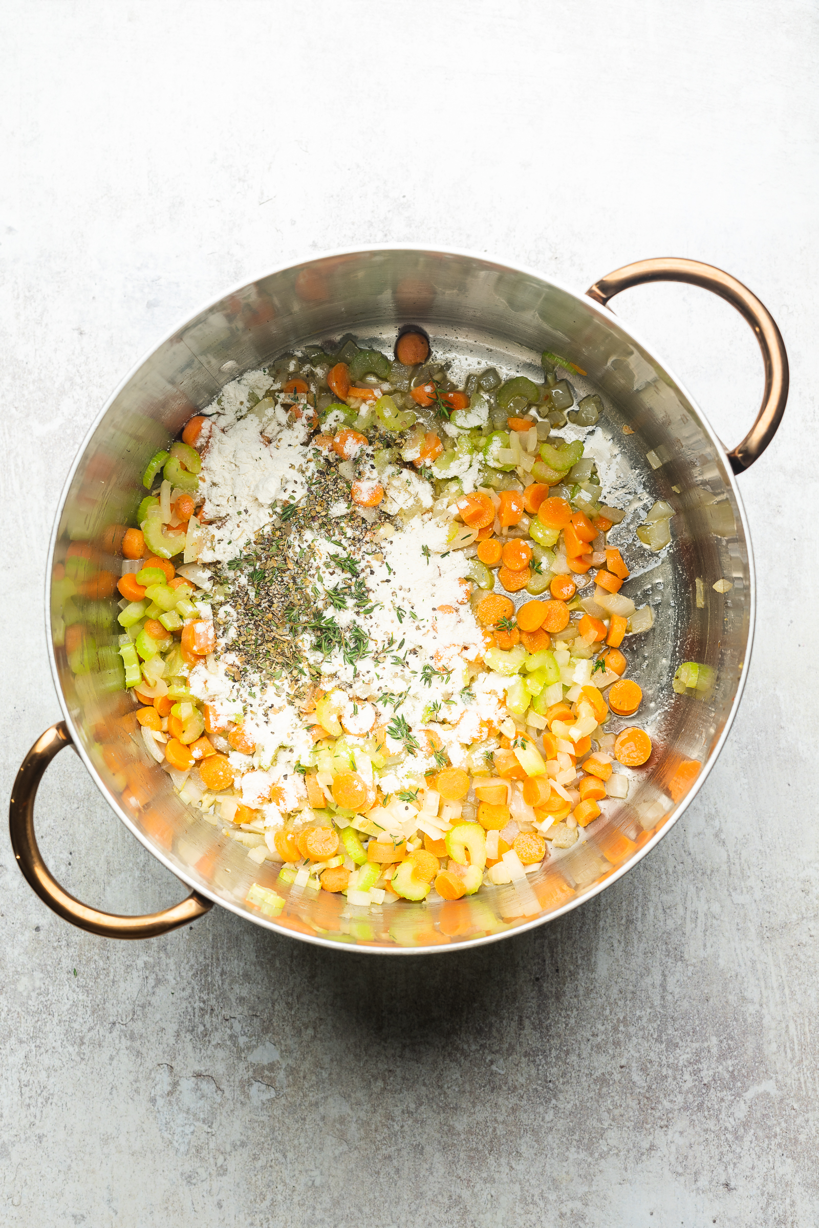 Cooked veggies, flour, and seasonings in a large soup pot.