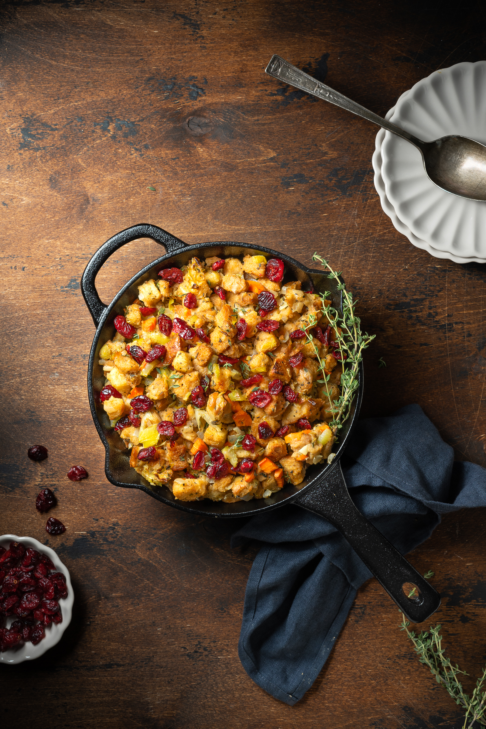 Stove top stuffing in a skillet, garnished with cranberries.