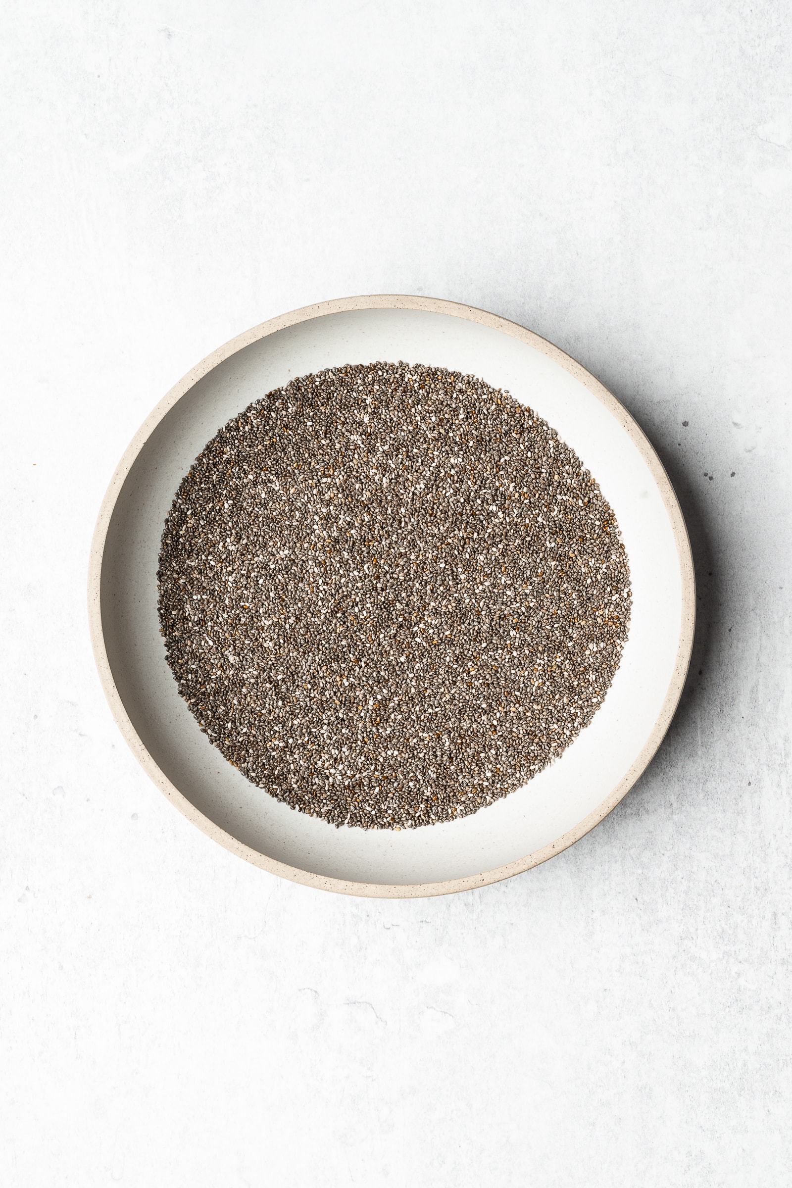 Chia seeds in a shallow bowl.