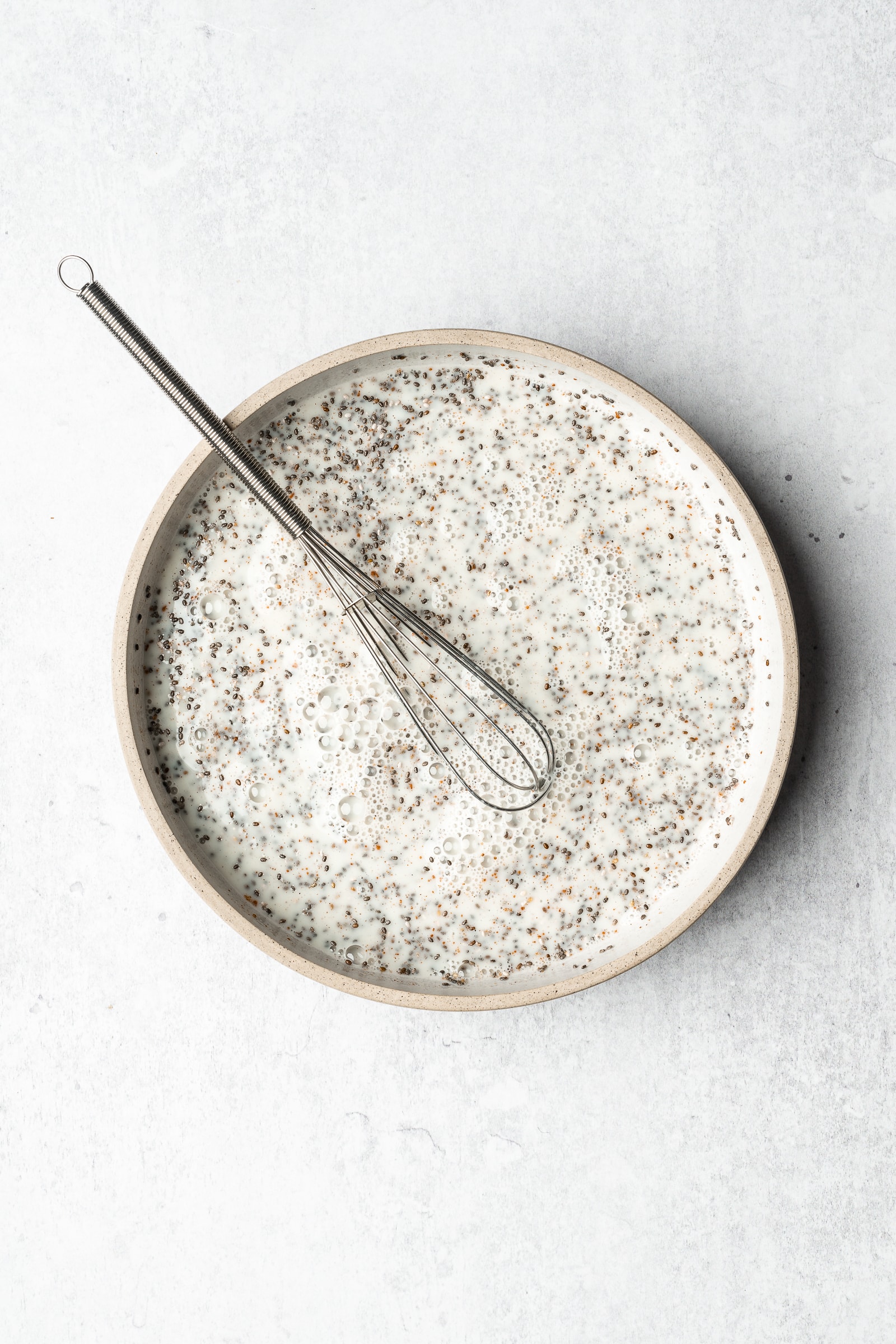 chia seed pudding in a shallow bowl before being refridgerated.