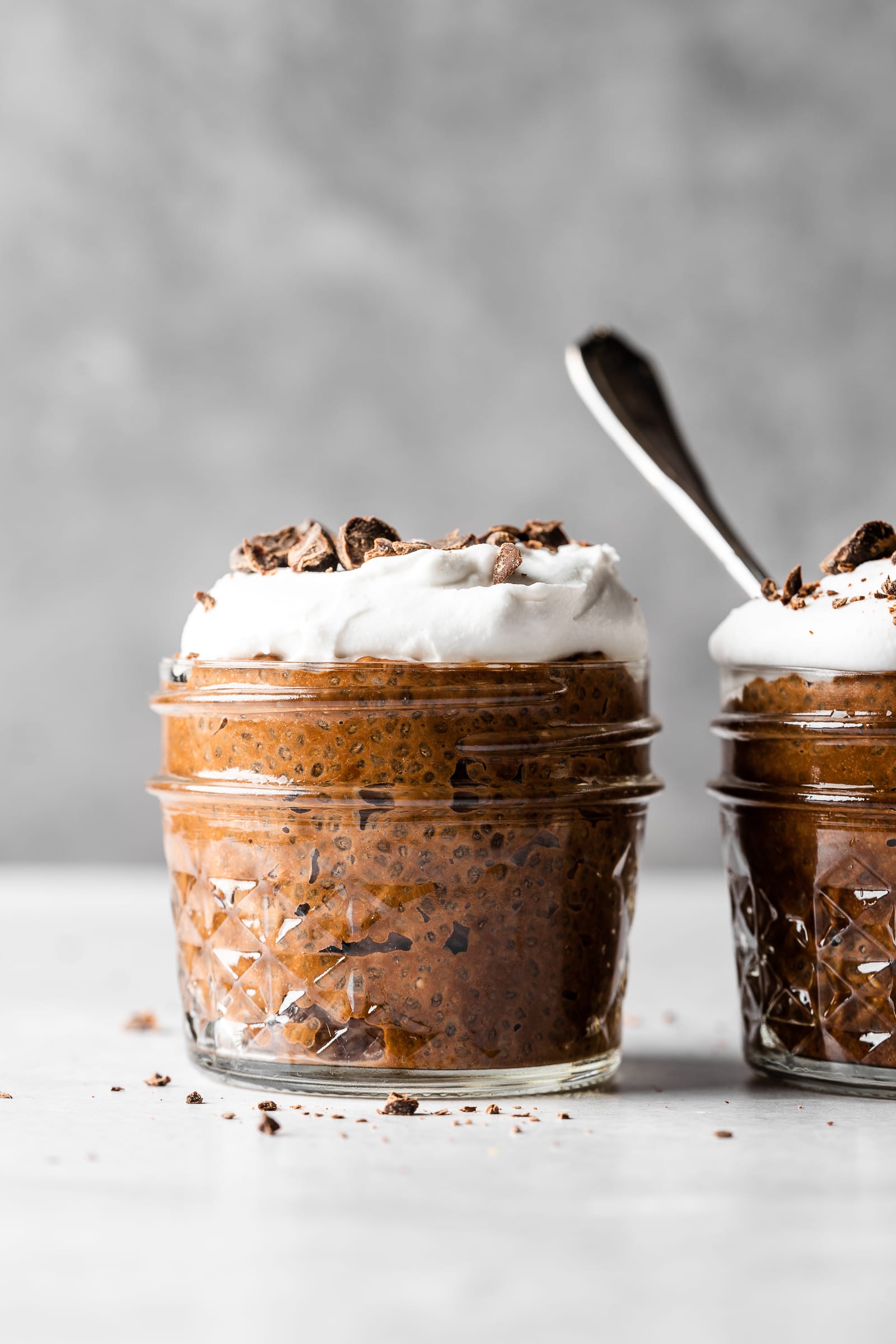 Chocolate chia pudding topped with coconut whipped cream and shaved chocolate.