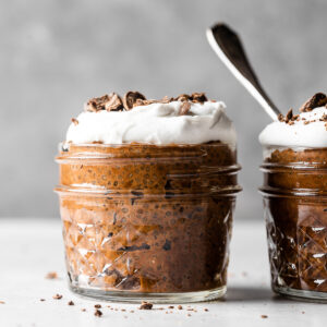 Chocolate chia pudding topped with coconut whipped cream and shaved chocolate.
