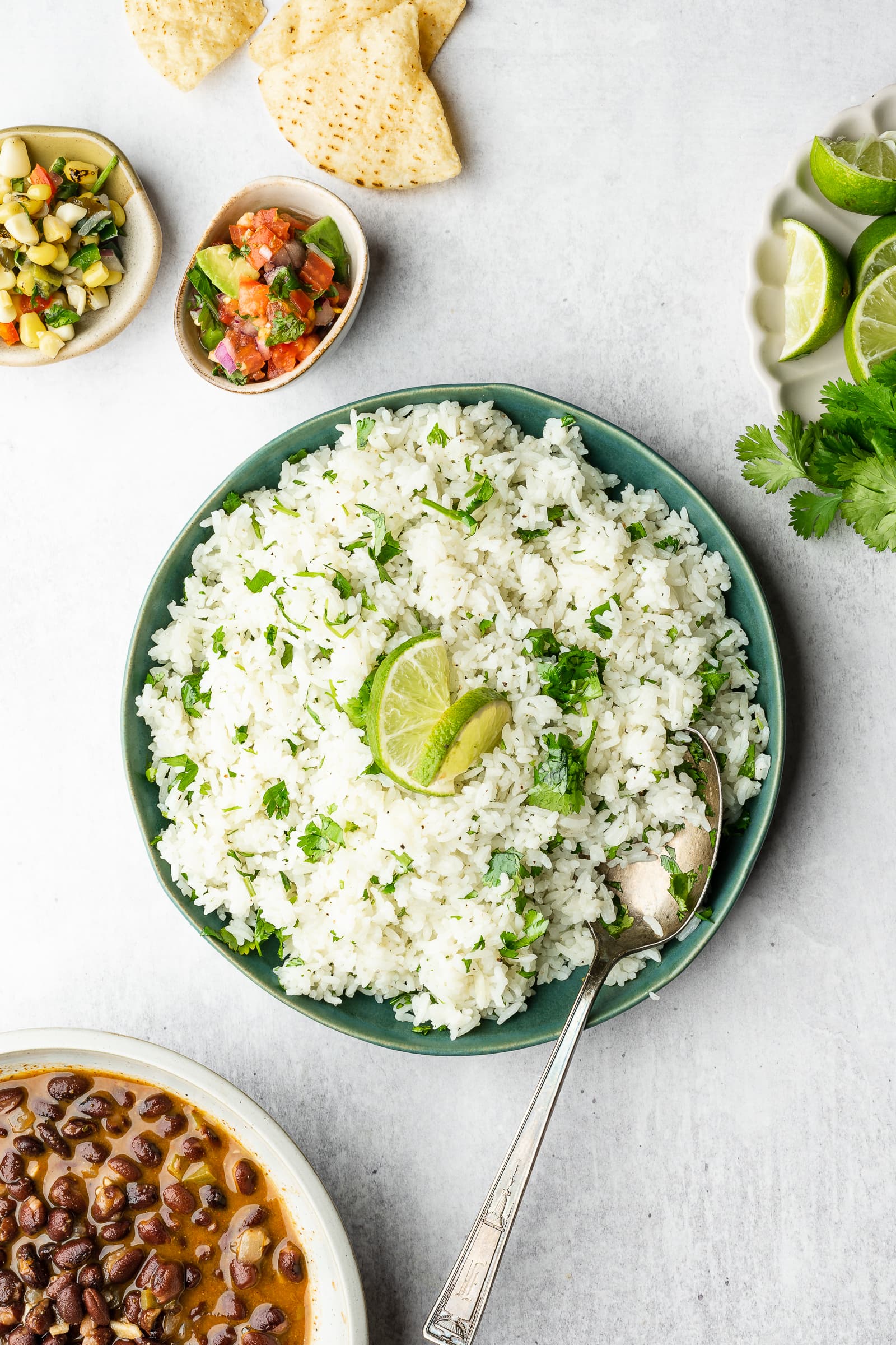 Cilantro lime rice in a serving dish garnished with lime.