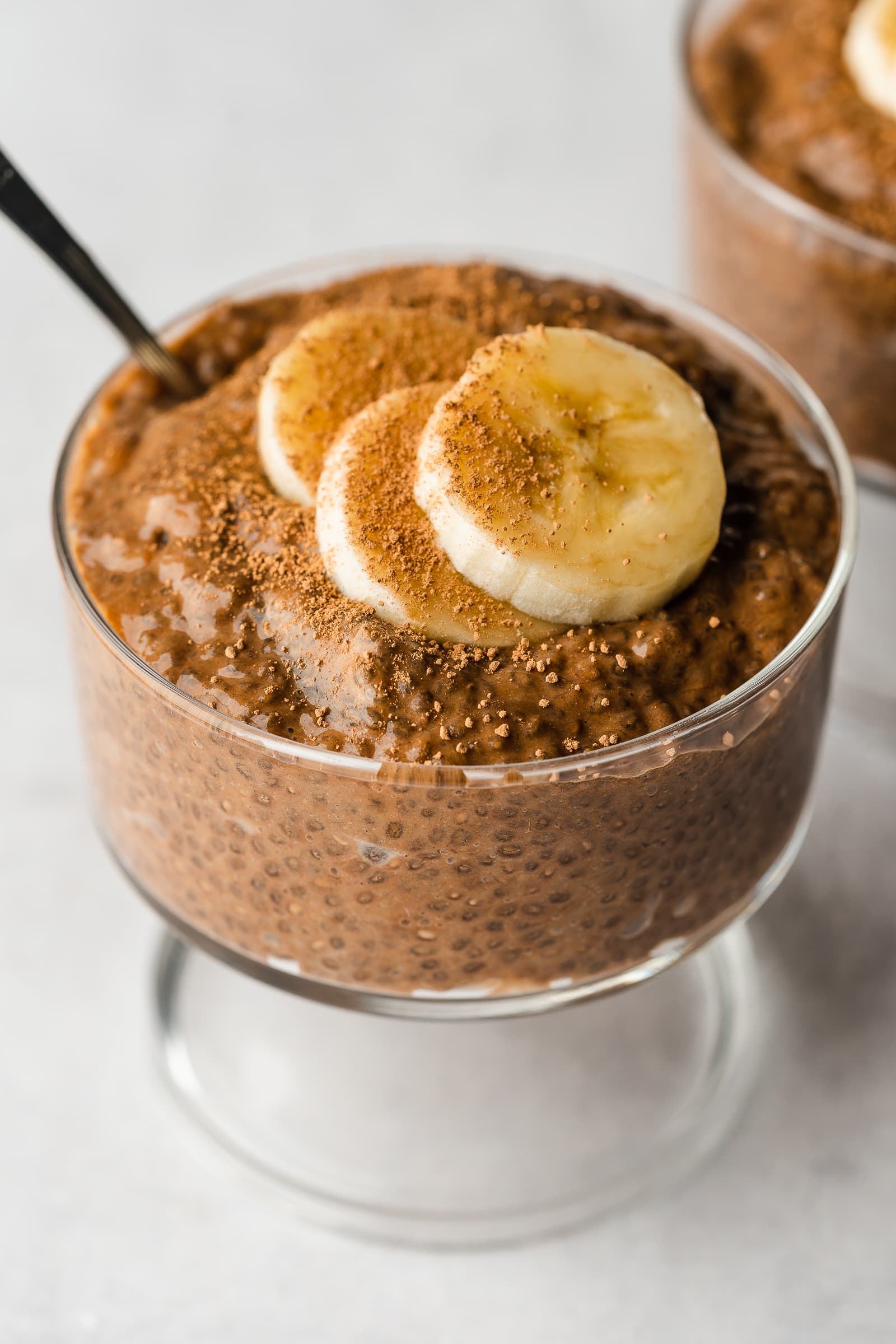 Chia pudding in glass jar garnished with banana slices.