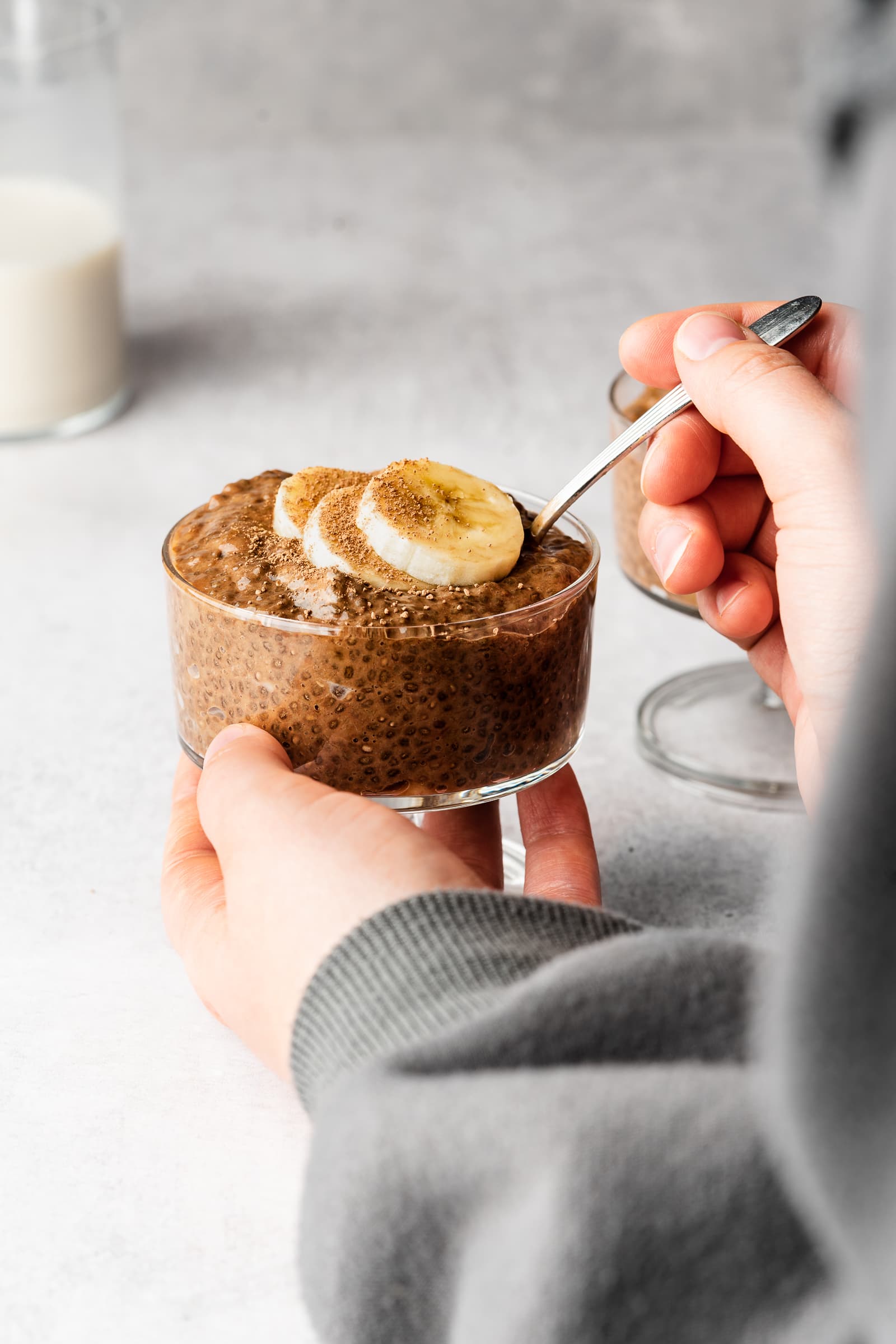 Chia pudding in glass jar garnished with banana slices.