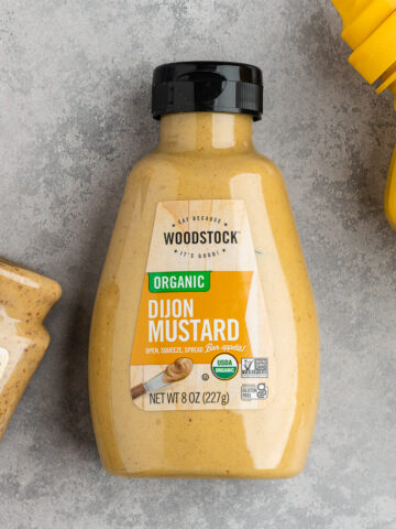Bottle of dijon mustard from the brand woodstock.