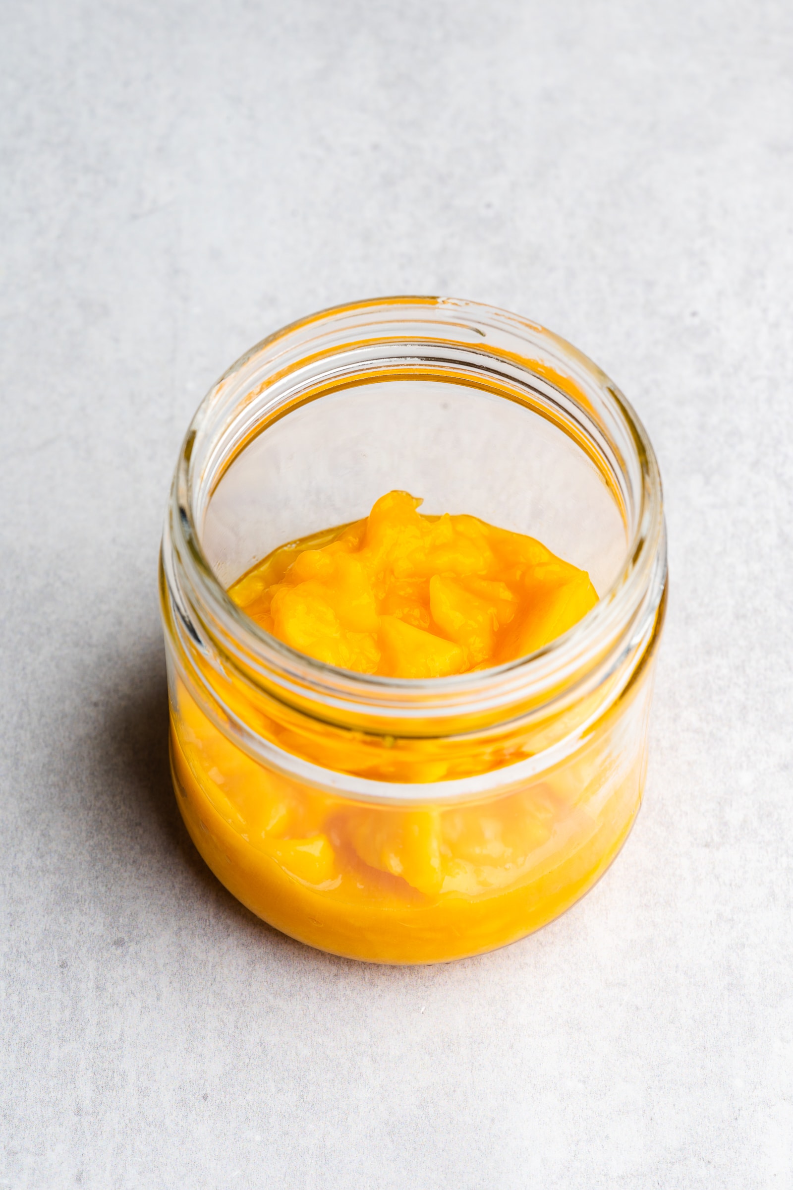 Mashed mango in jar.