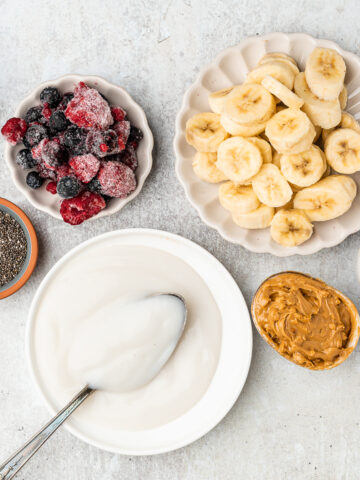Yogurt substitutes for smoothies including sliced bananas, vegan yogurt, frozen berries, chia seeds, and peanut butter.