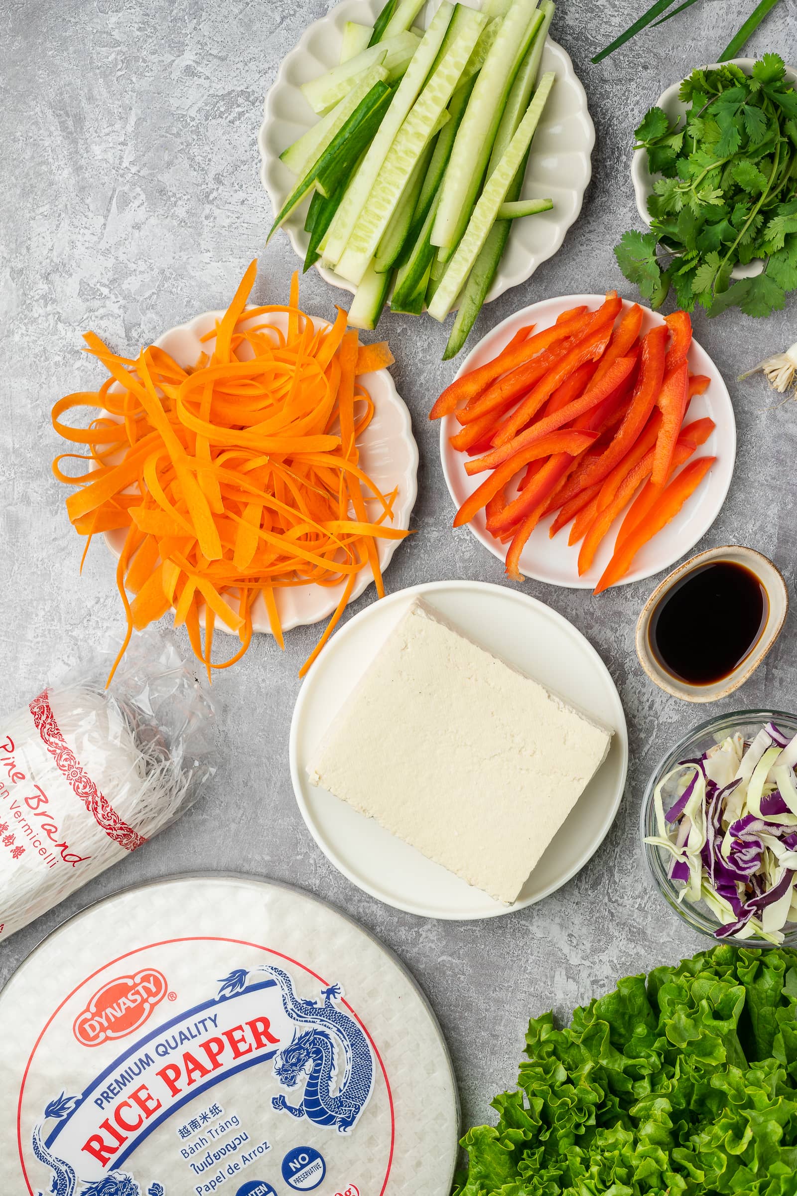 Tofu rice paper roll ingredients on small plates.