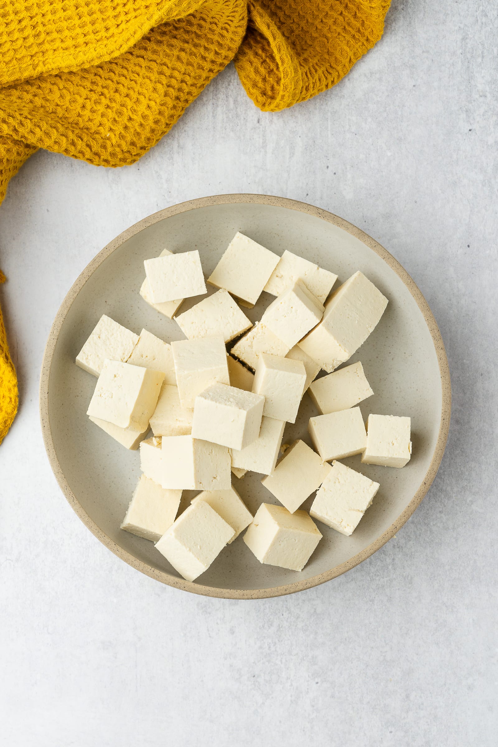 Cubed tofu in a shallow bowl.