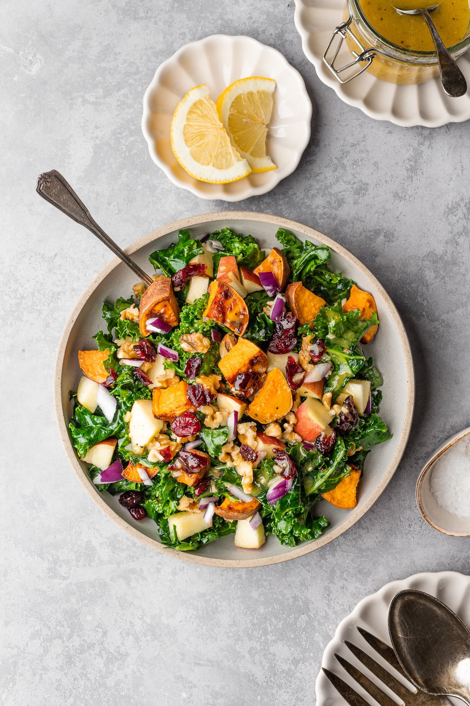 Kale salad with maple mustard dressing, sweet potatoes, apples, and cranberries.