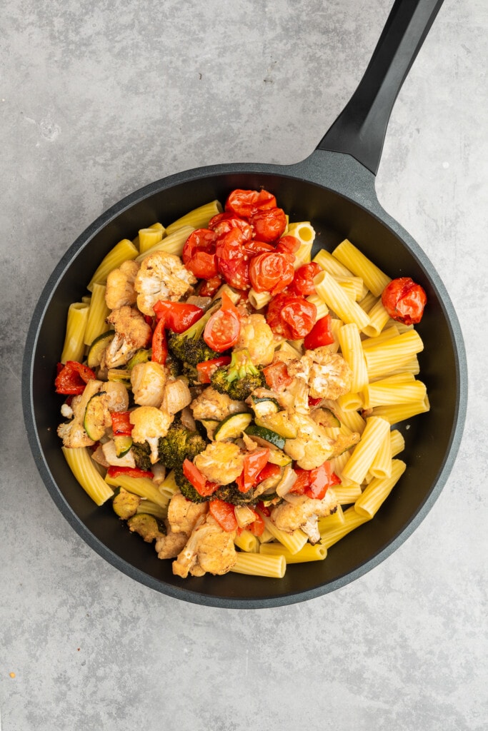 Cooked pasta and vegetables in a pan.